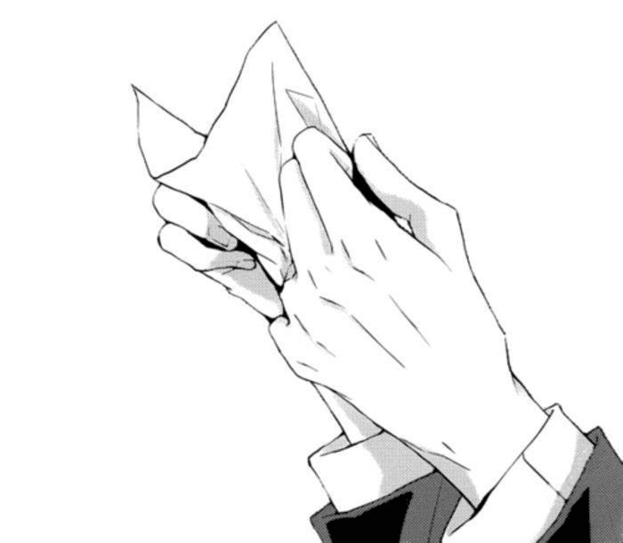 A hand tightly gripping a crumpled paper.
